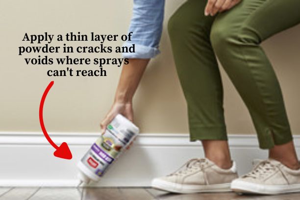 An image of someone using Ortho bed bug killer powder along cracks and voids where sprays can't reach.